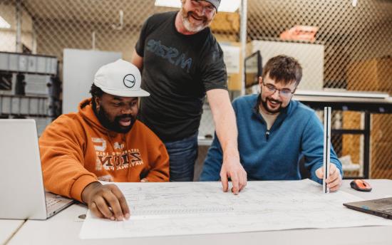 Photo of construction management students reviewing blueprints