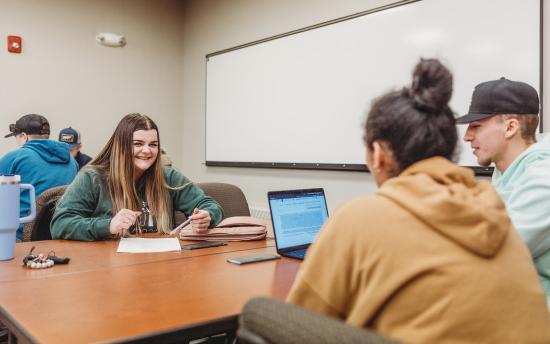 Photo of criminal justice students working on a group project in a classroom